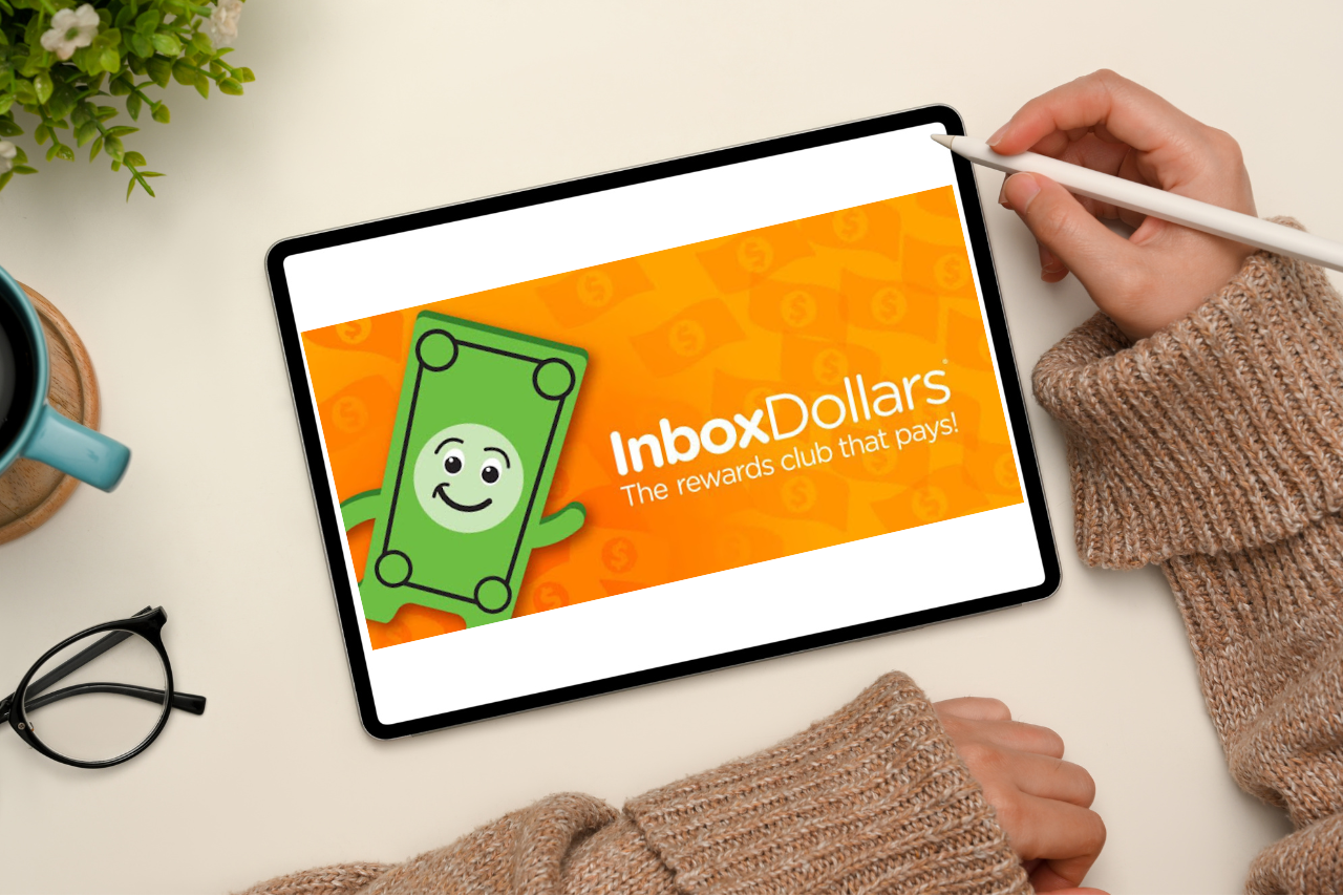 Woman accessing InboxDollars website on ipad.