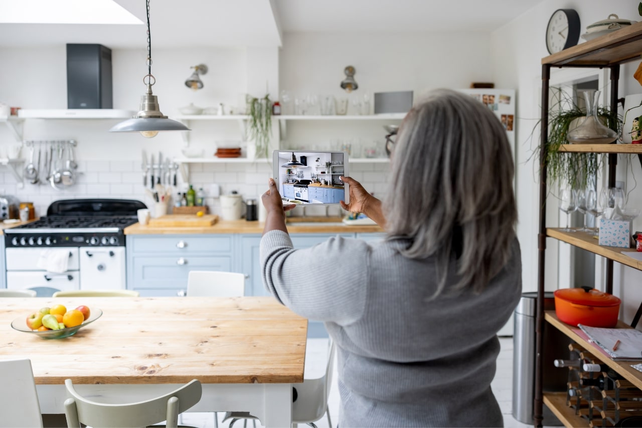 Woman taking pictures of her house.