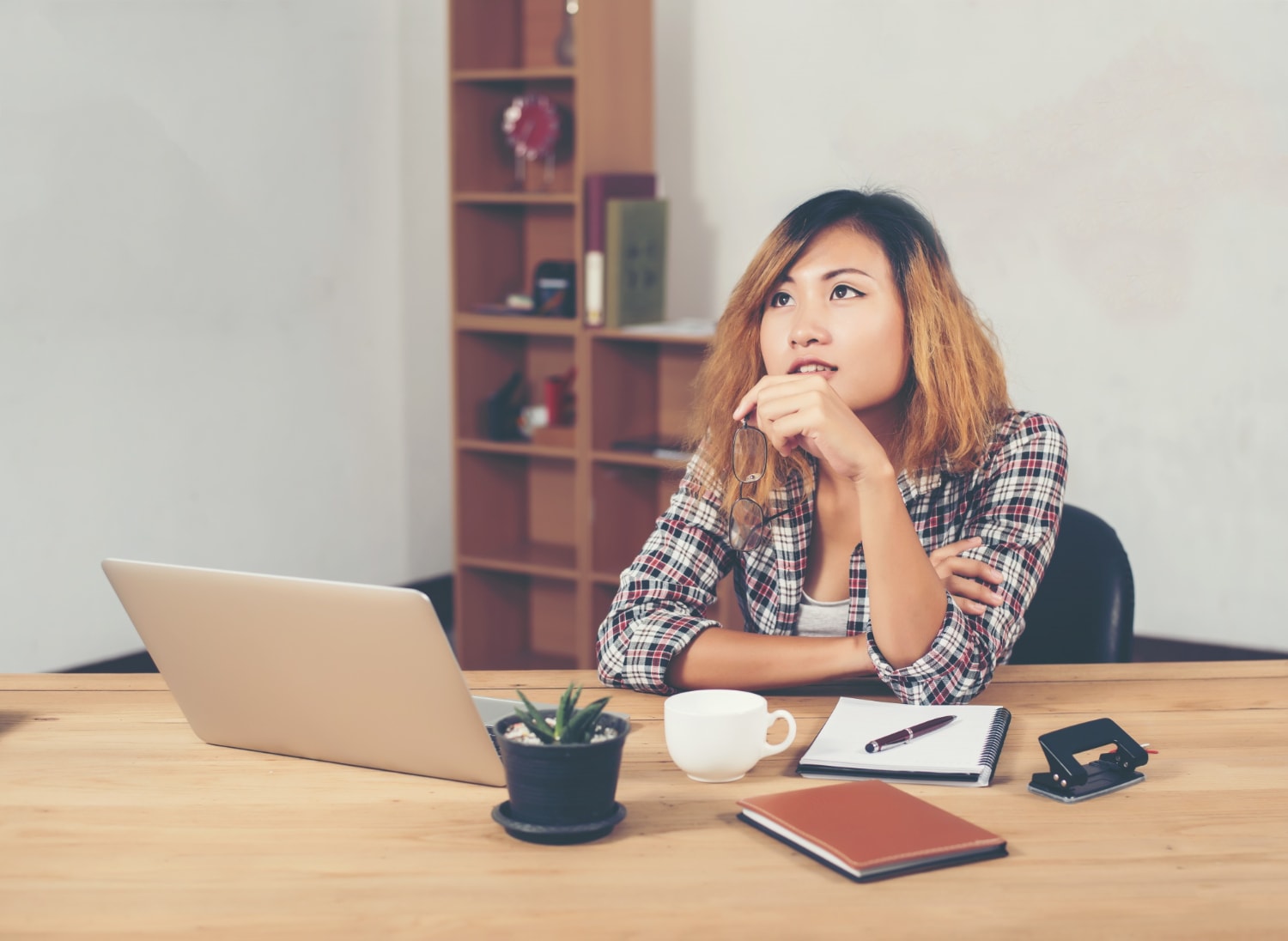 Woman thinking at work.