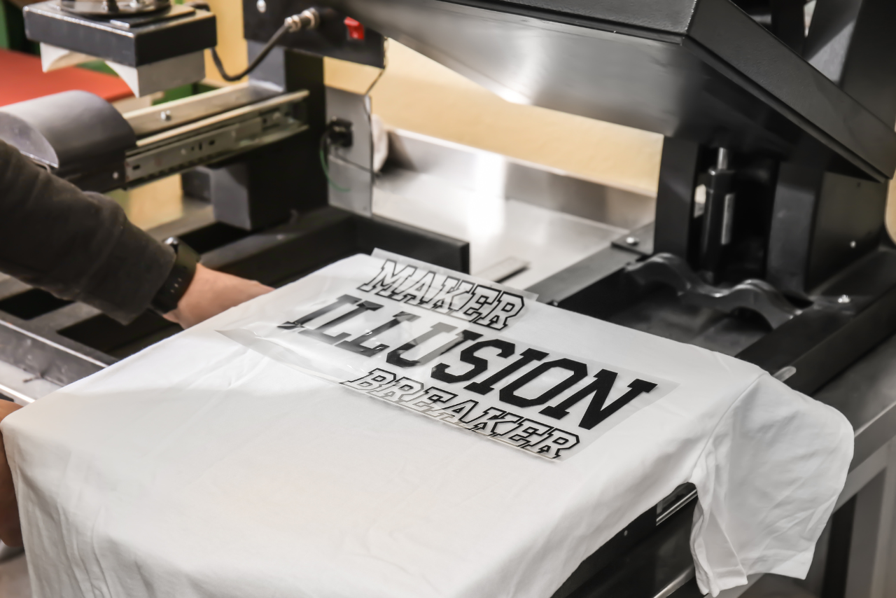Young man printing t-shirt.