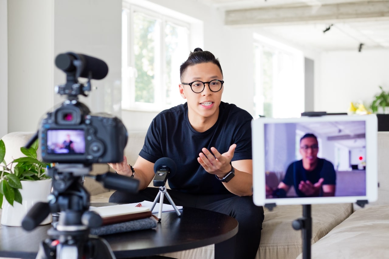 Young man recording himself for channel content.