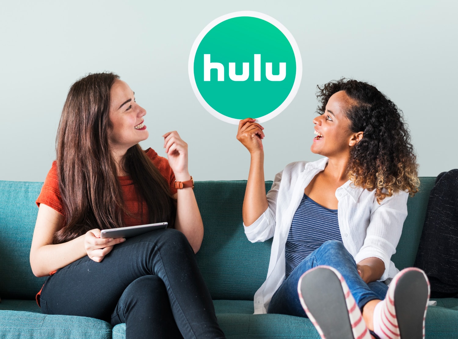 Young women showing a hulu icon.