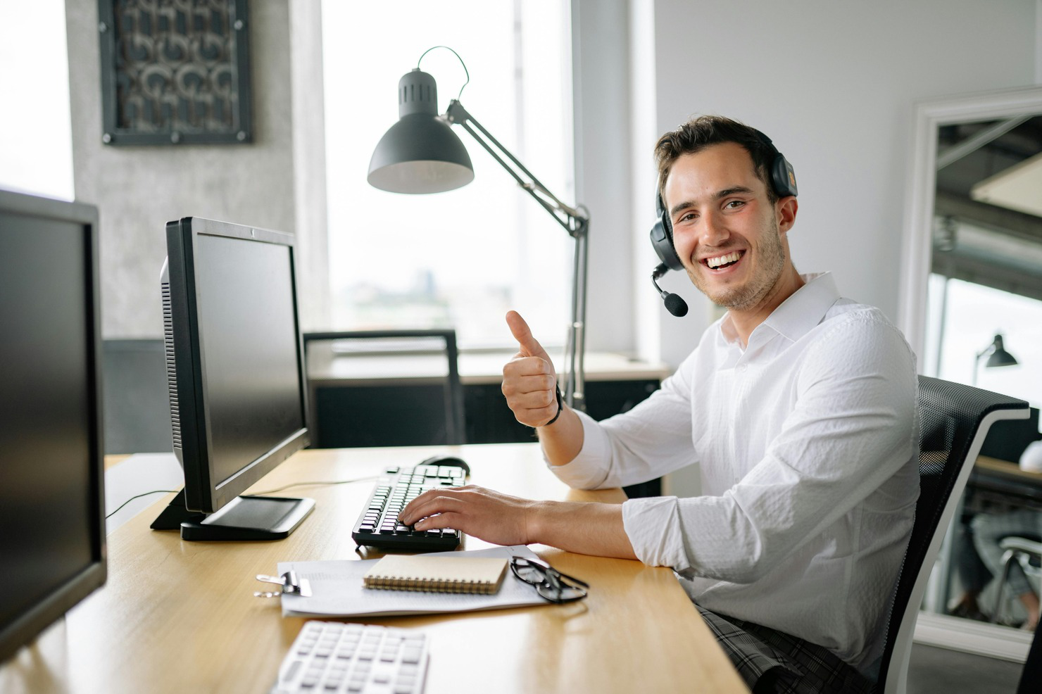 A Man Working in an Office while Wearing a Headset.