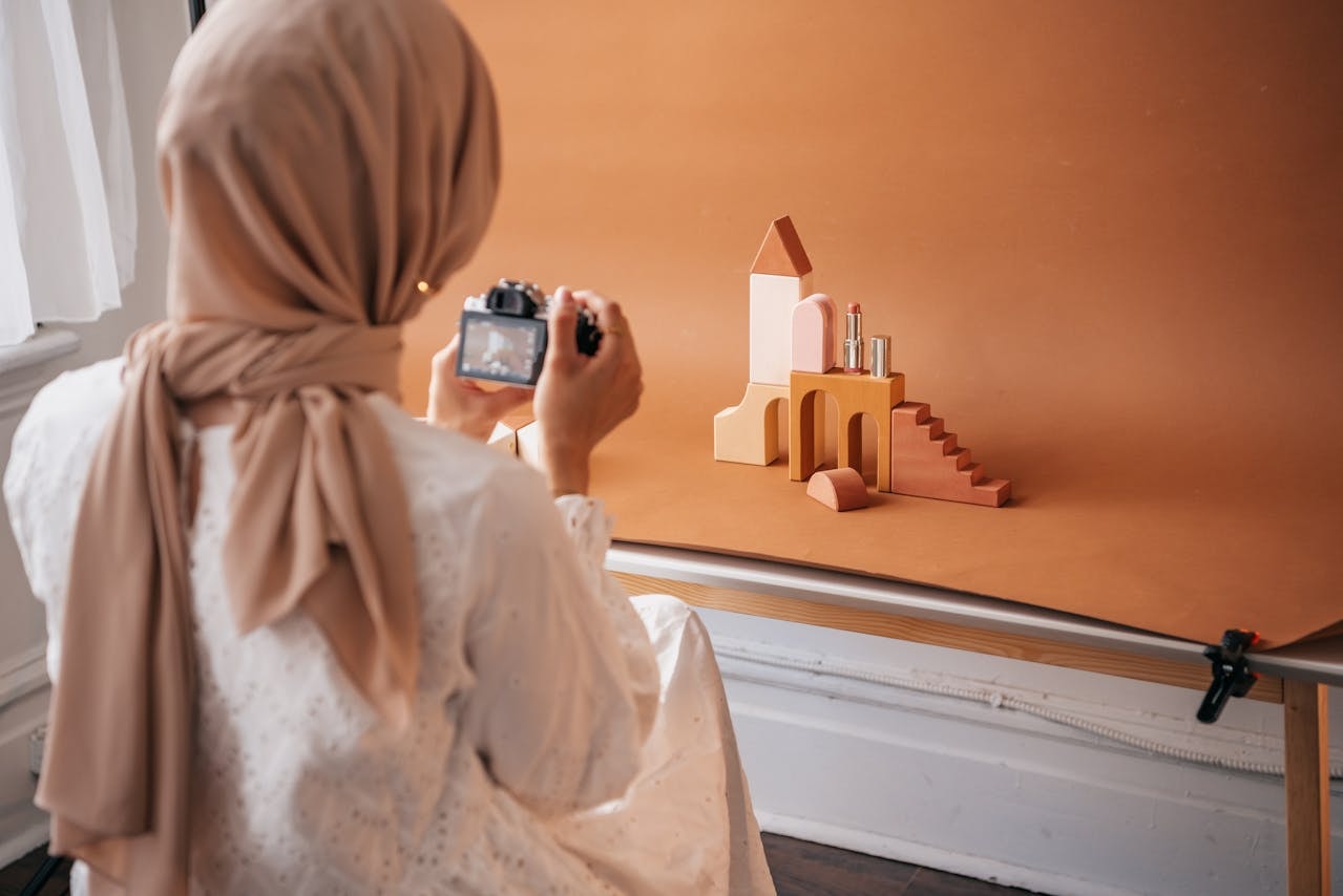 A Photographer Taking Photos of Wooden Blocks and a Lipstick.