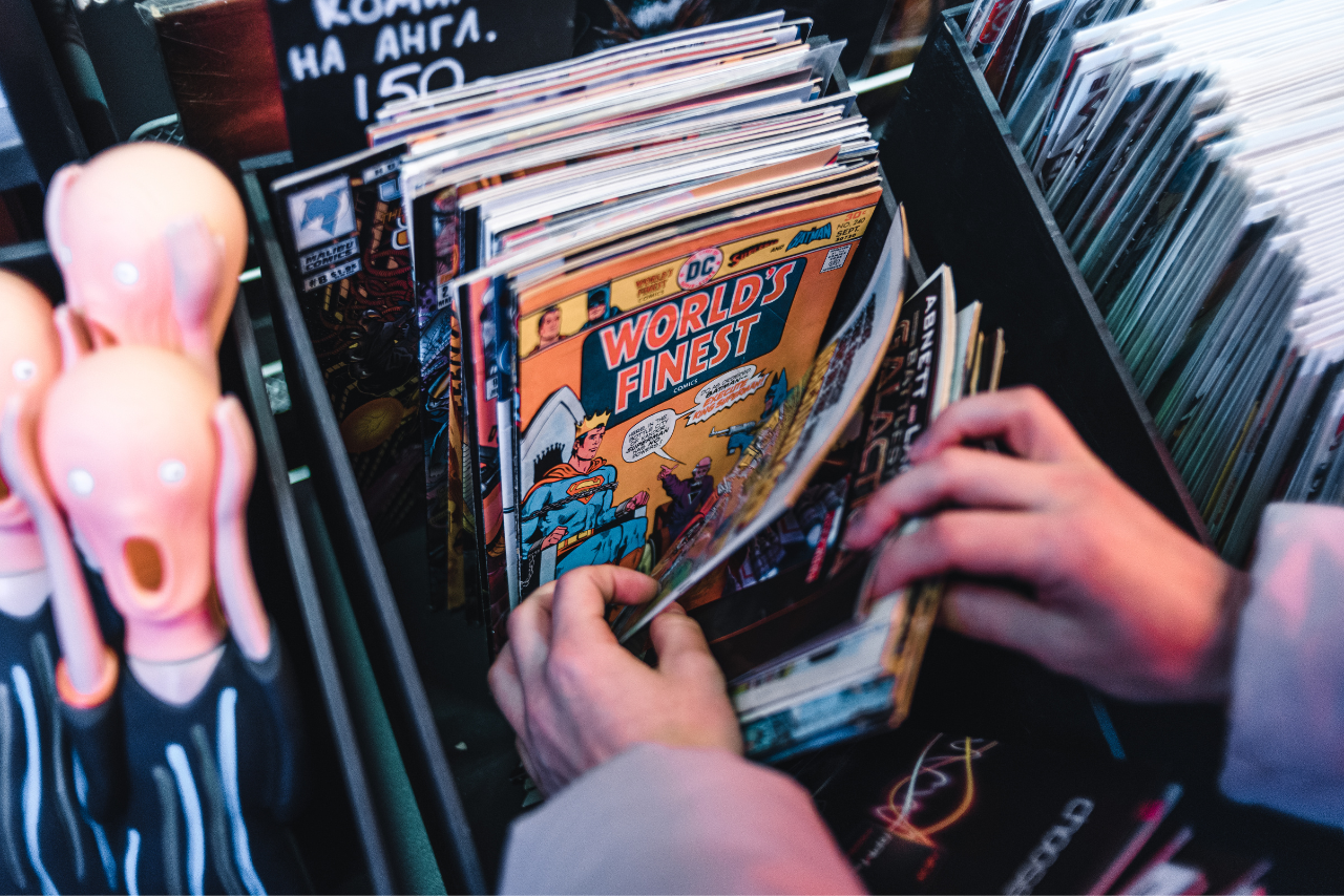 A close-up shot of a person holding Books and showing World's Finest Comic.