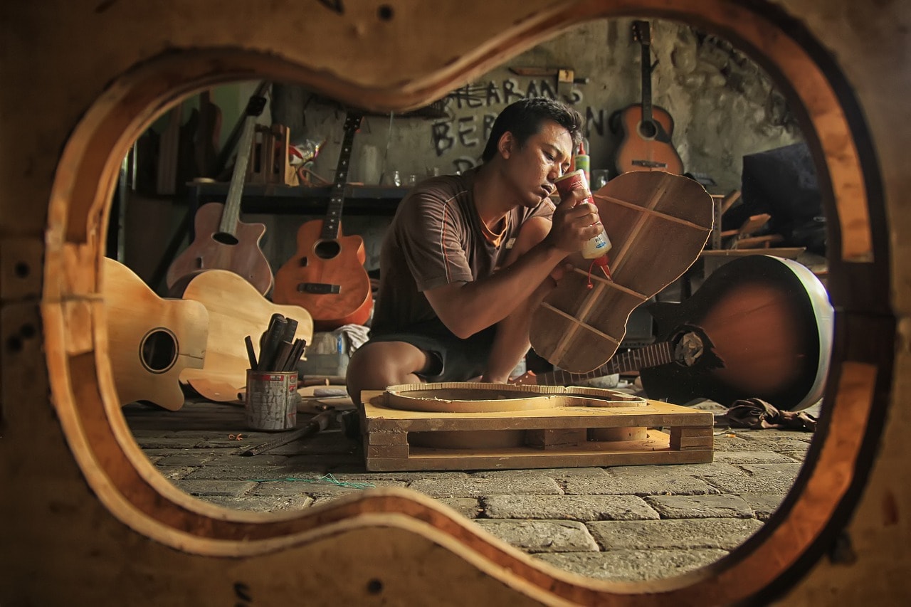 A man making an acoustic guitar