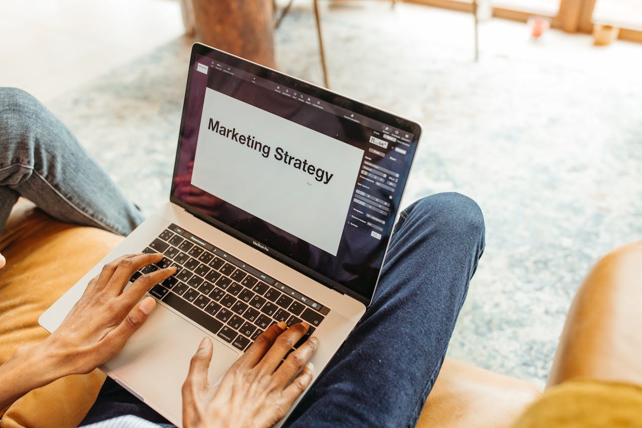 A person creating a marketing strategy on a laptop