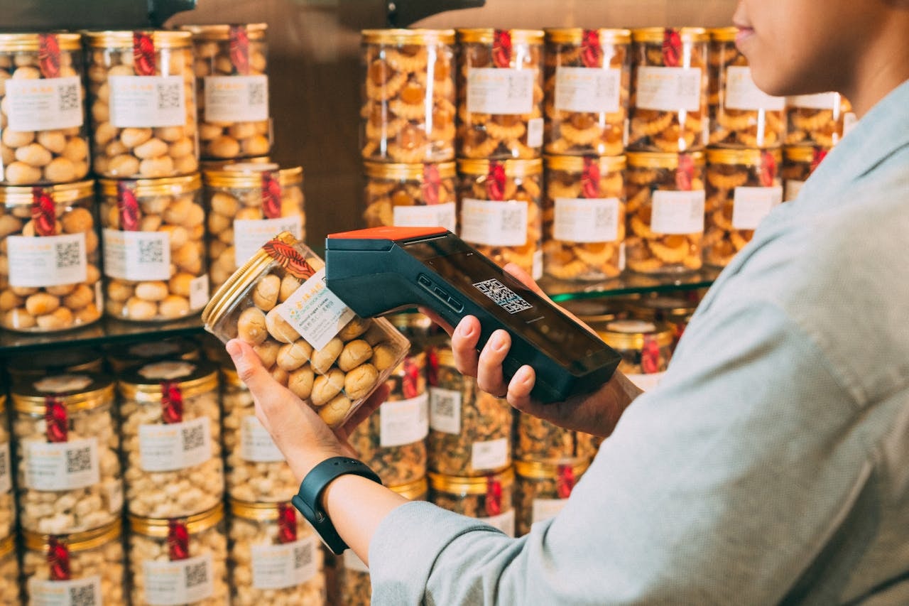 A person scanning a QR code on a jar of cookies