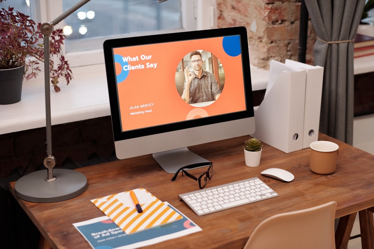 A photo of a computer monitor on a table showing a presentation