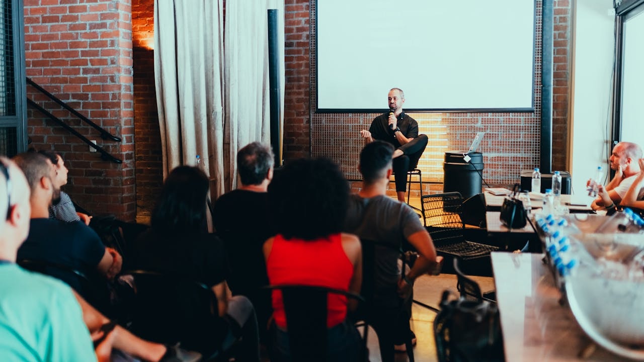 A photo of a man speaking in front of an audience