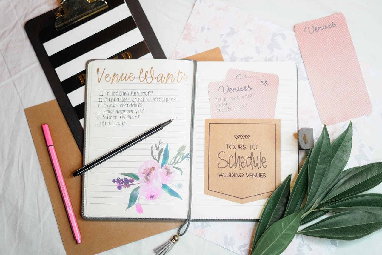 A photo of a planner with wedding venue stuff written in it
