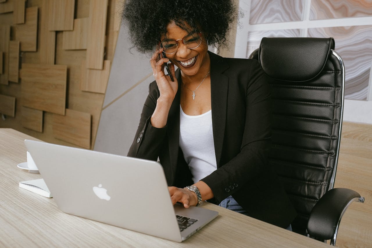 A woman smiling and talking on the phone