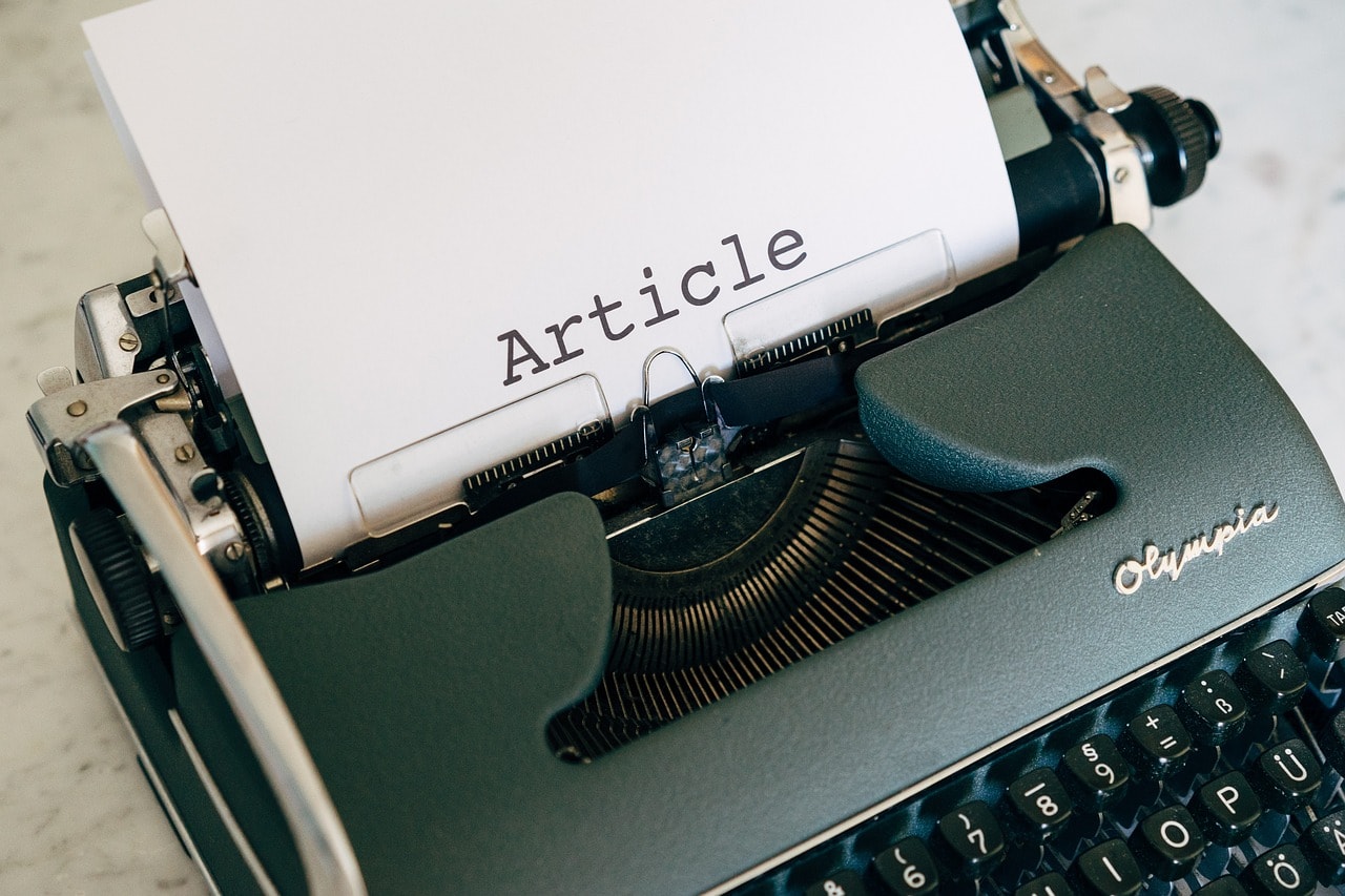 A word Article written on a paper in a typewriter.