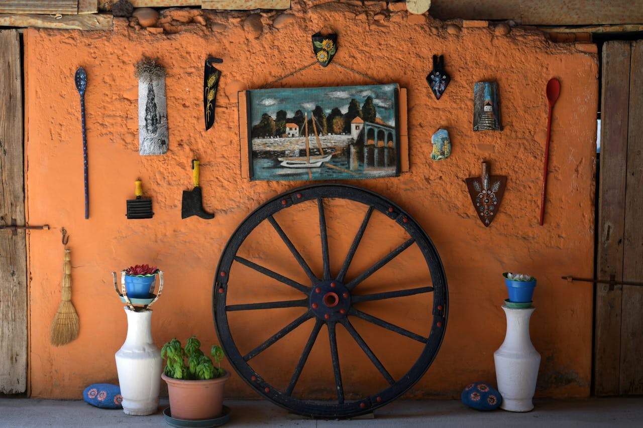 An artwork hanging on an orange-painted wall