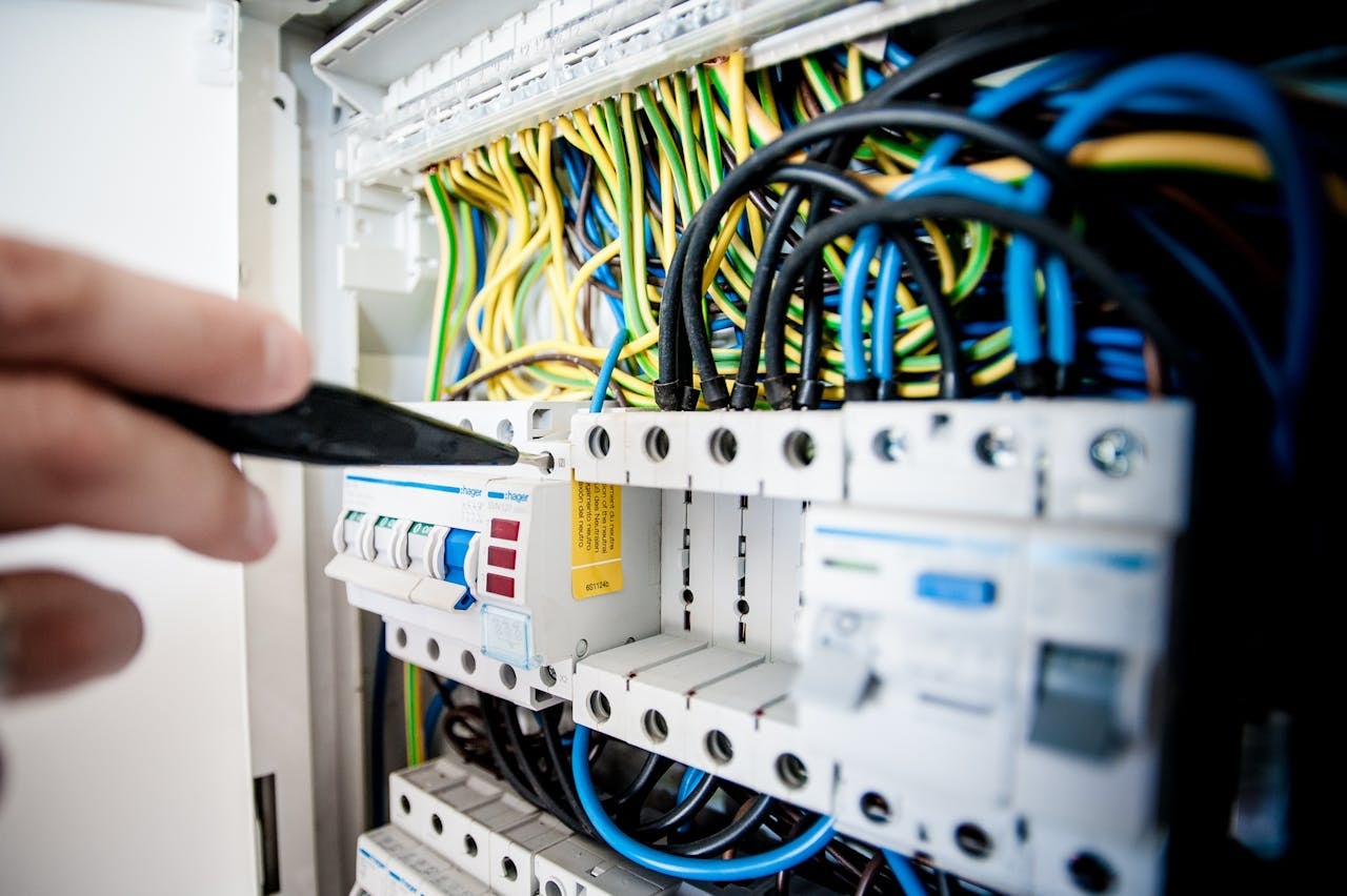 An electrician fixing an open switchboard