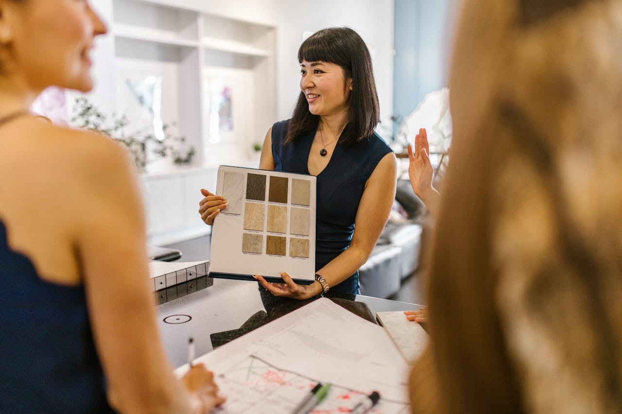 An interior designer showing a folder of color palette to customers