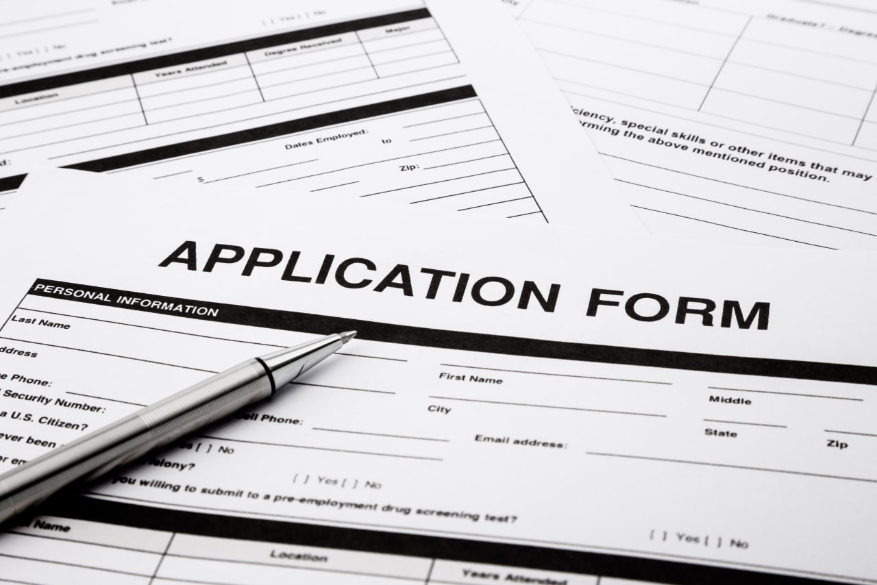 Application form on table with pen.