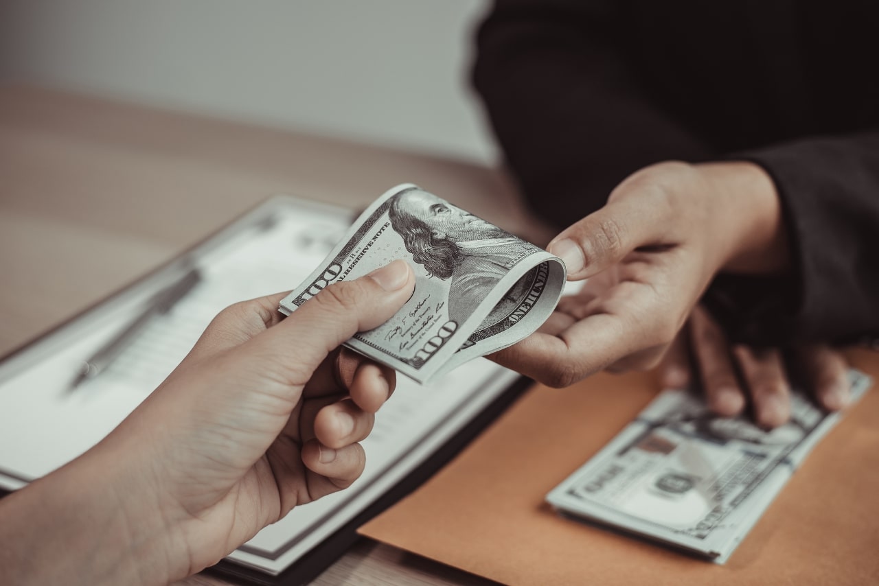 Business person paying state filling fee.