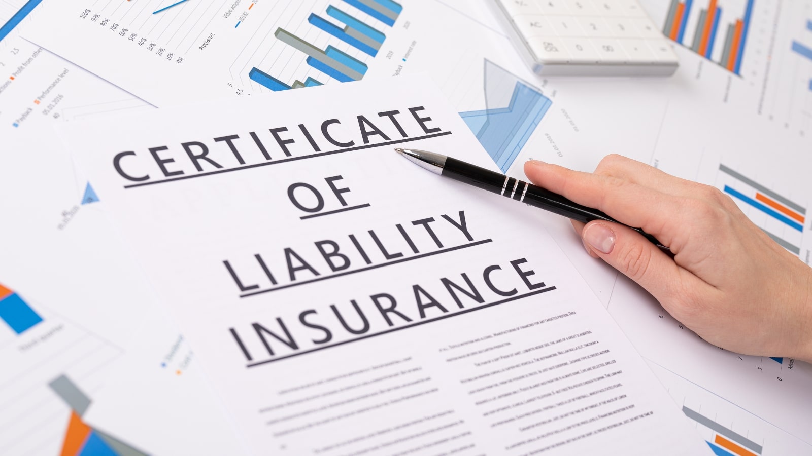 Certificate of liability insurance concept, documents on the desktop.