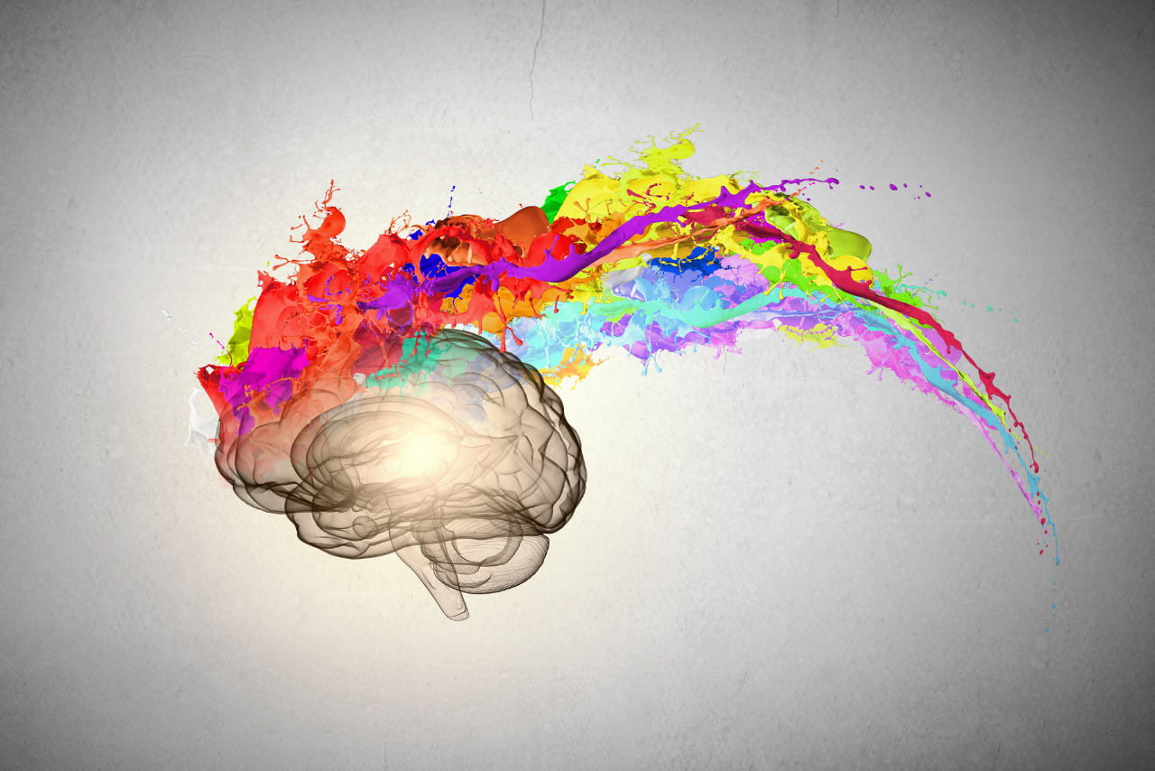 Conceptual image of human brain in colorful splashes.