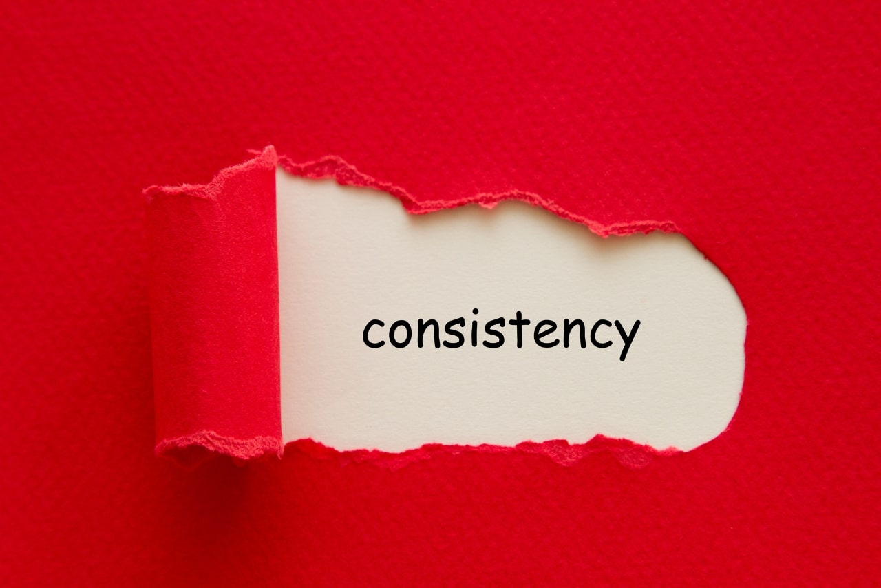 Consistency word written under red paper.
