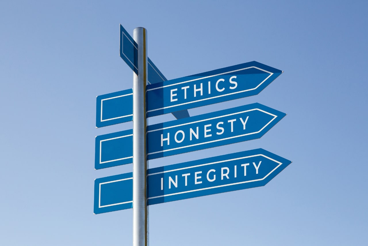 Ethics, Honesty and Integrity Words on Signpost Isolated on Sky Background.
