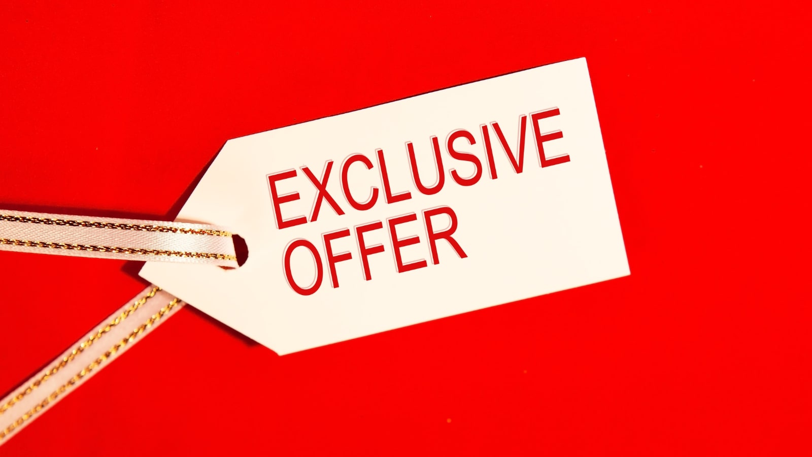Exclusive offer - text on white label on red background.