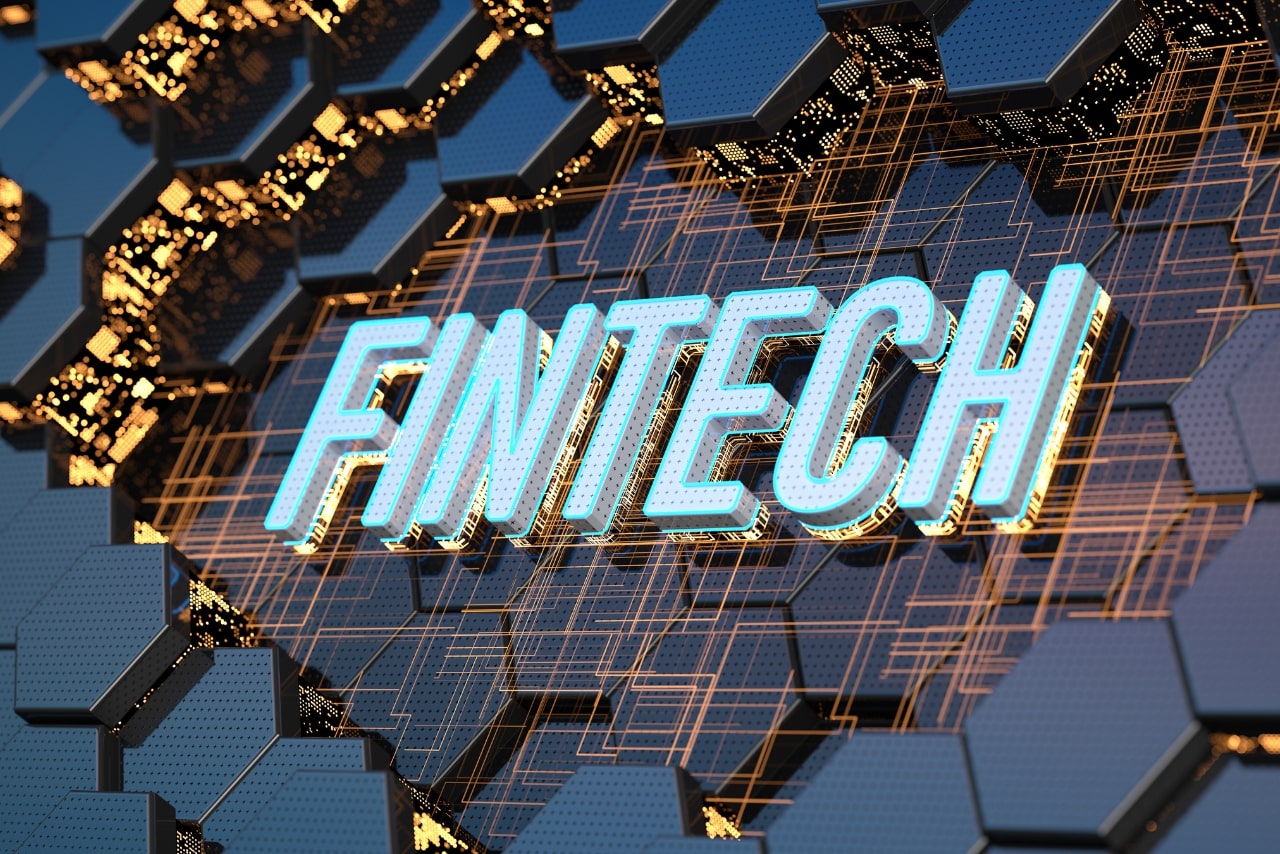 Fintech text on technology background.
