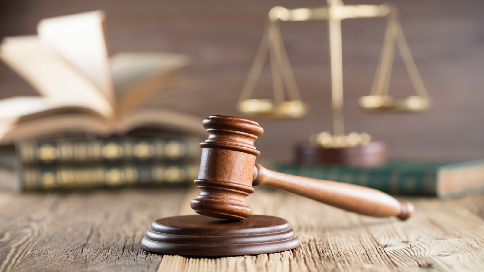 Gavel, legal scales and books.