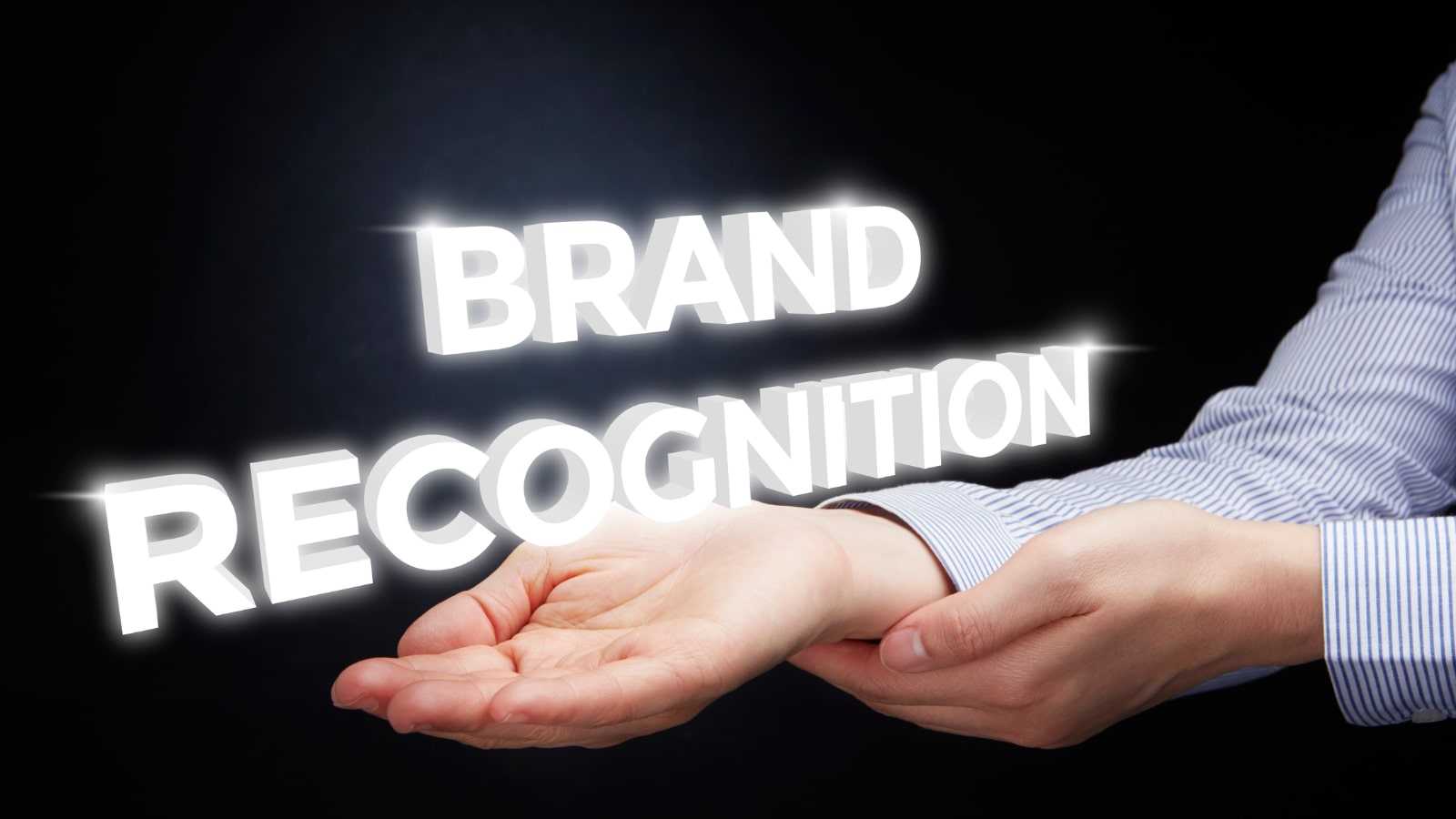 Hand showing digital text: brand recognition.