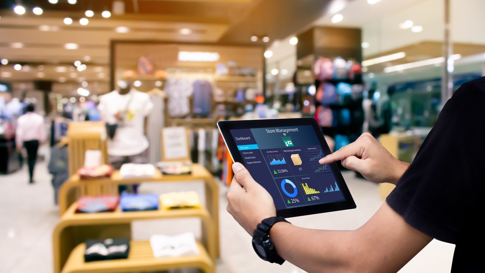 Male manager using smart store inventory management systems in store.