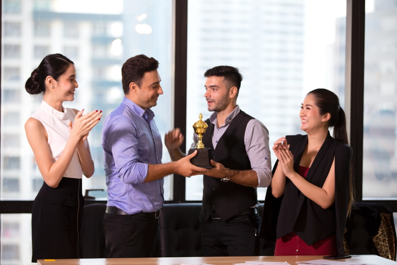 Manager Giving Trophy to Employee.