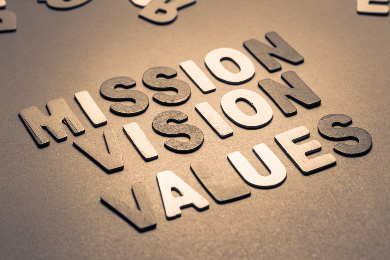 Mission, Vision & Values text in wooden letters.