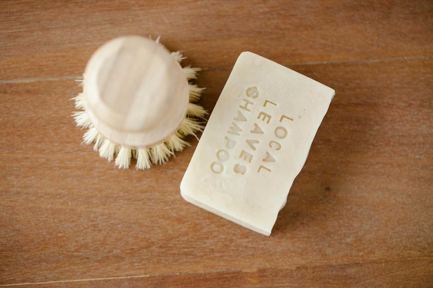 Natural Solid Shampoo Bars beside scrub.