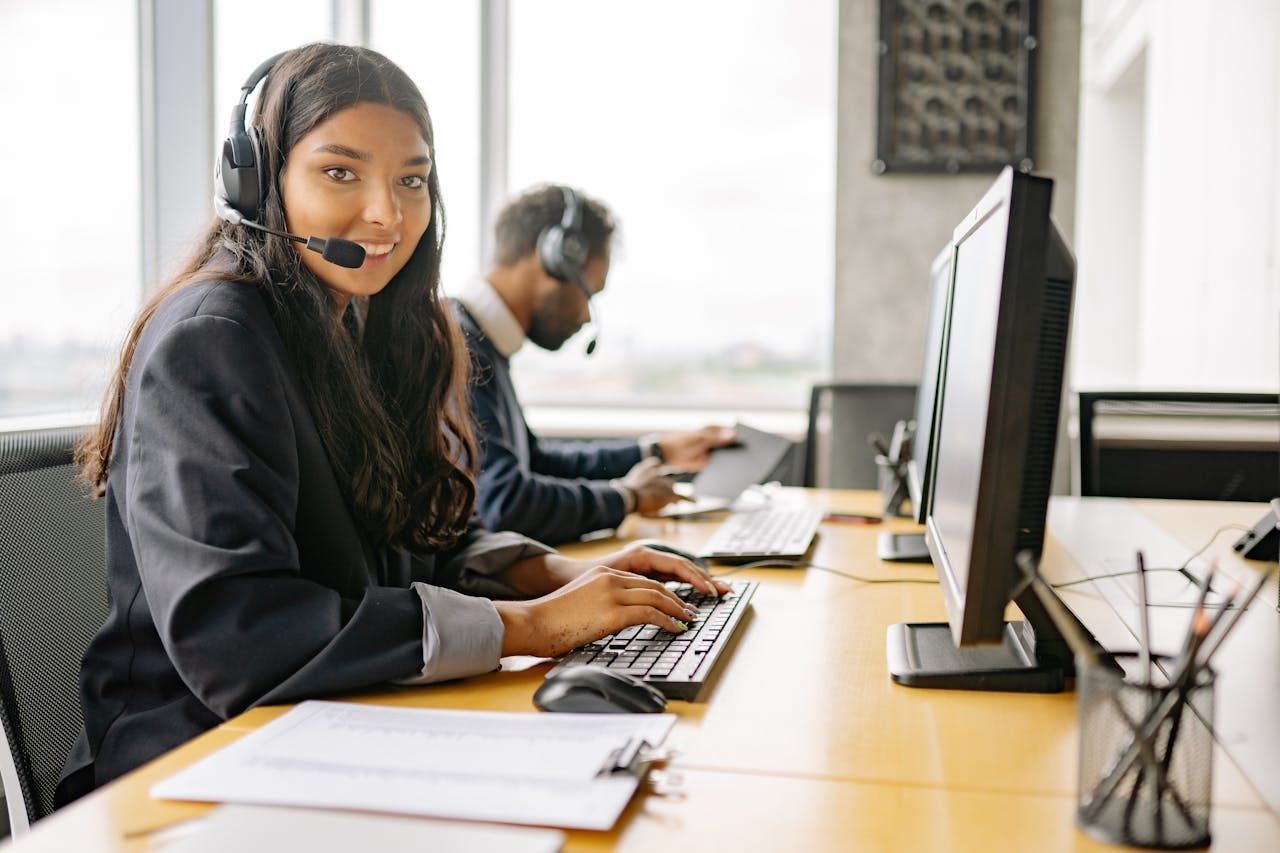 People in their workstation wearing headsets