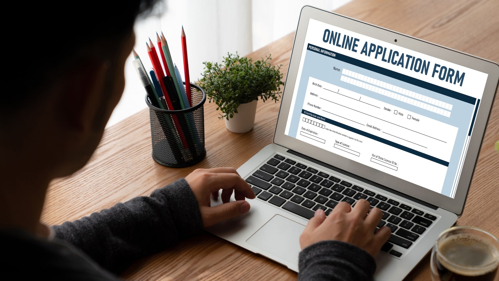 Person filling out application form for affiliate program online.