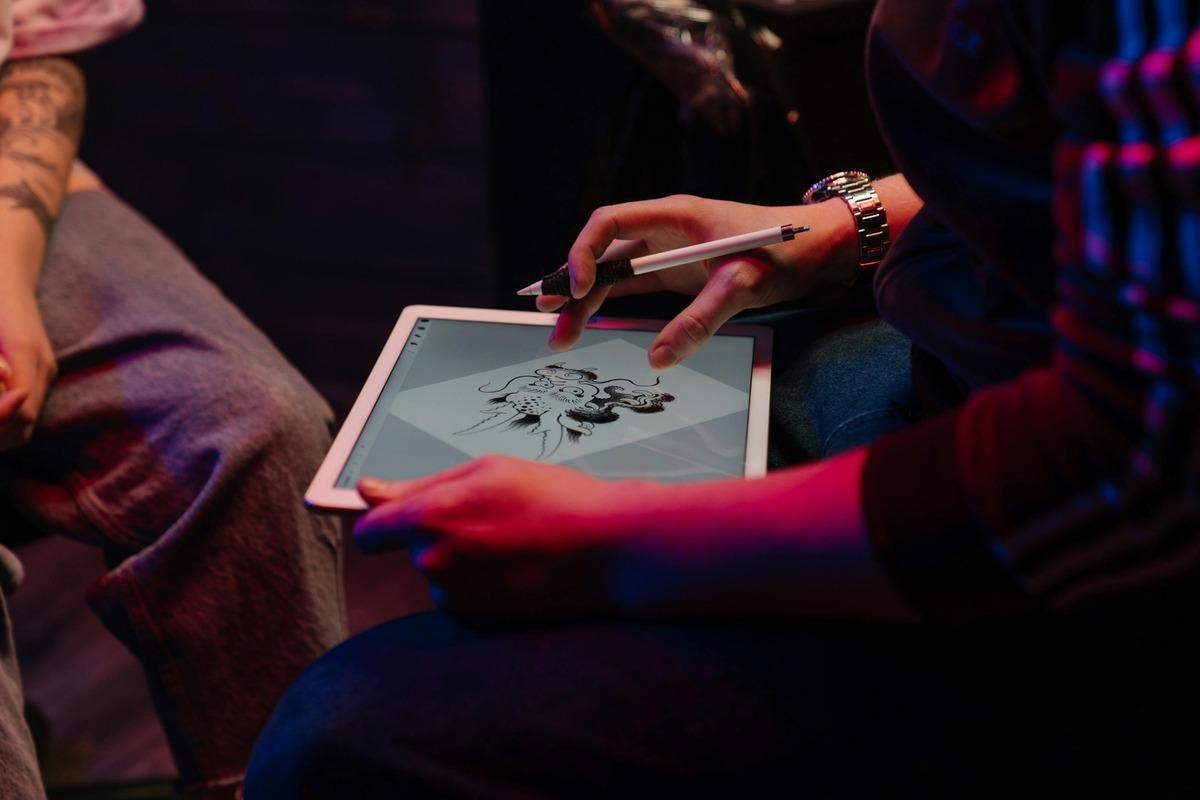 Person in Blue Shirt Holding White Tablet_1