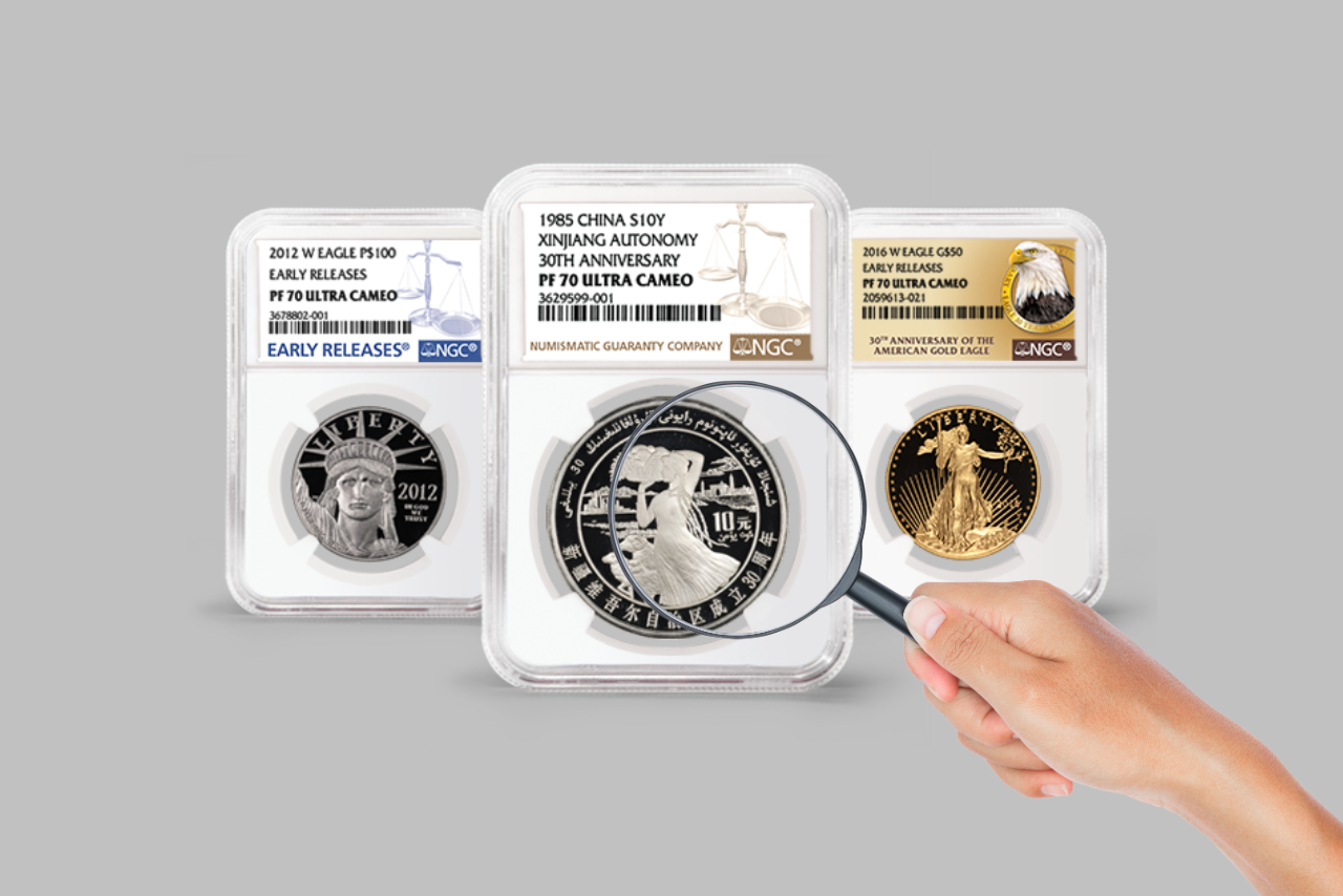 Person's hand using magnifying glass and practicing coin grading.