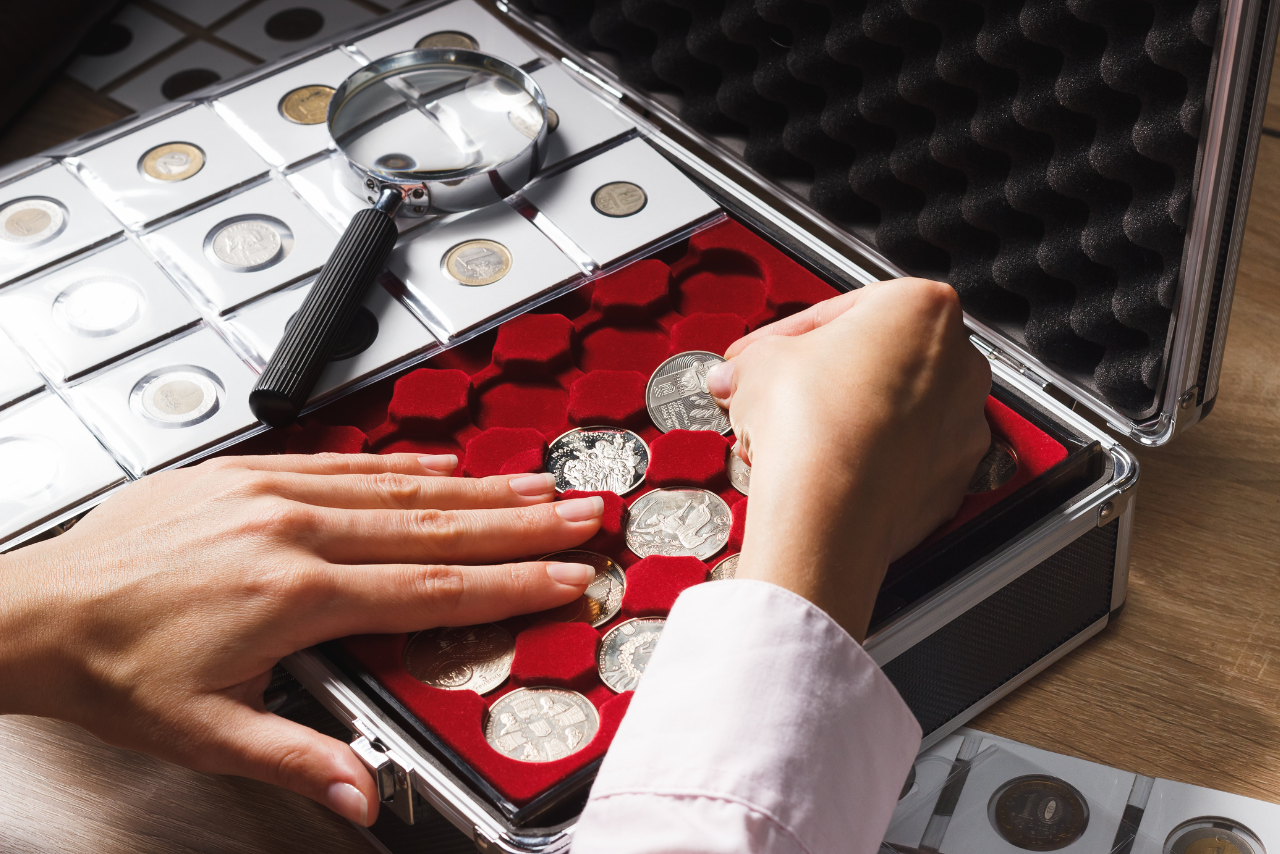 Professional coin cleaner carefully placing coins in a safe case for preservation.