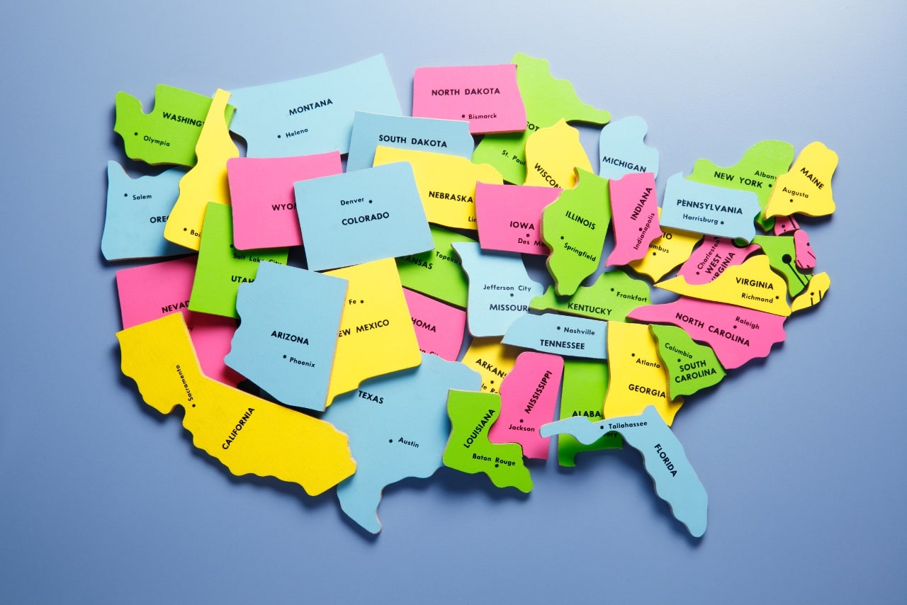 Randomly placed puzzle pieces representing the 50 states of the United States.