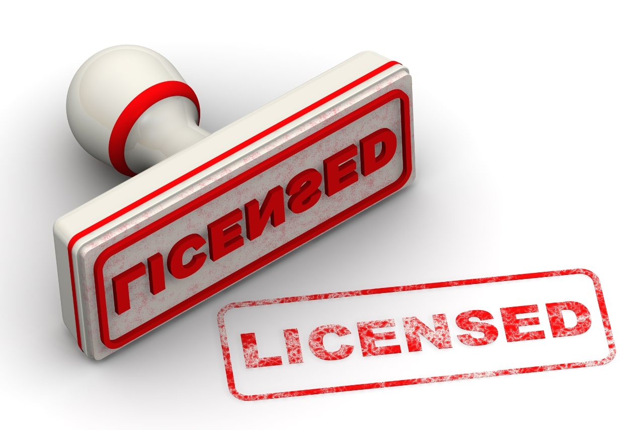 Red stamp and imprint Licensed on white surface.