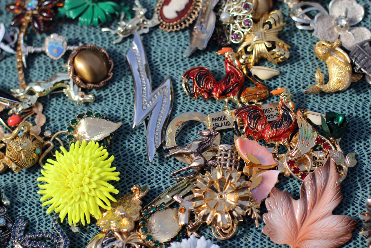 Selection of vintage pins and brooches at flea market.