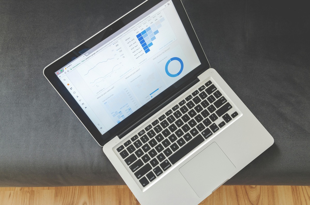 Turned-on Laptop Computer with google analytics report.