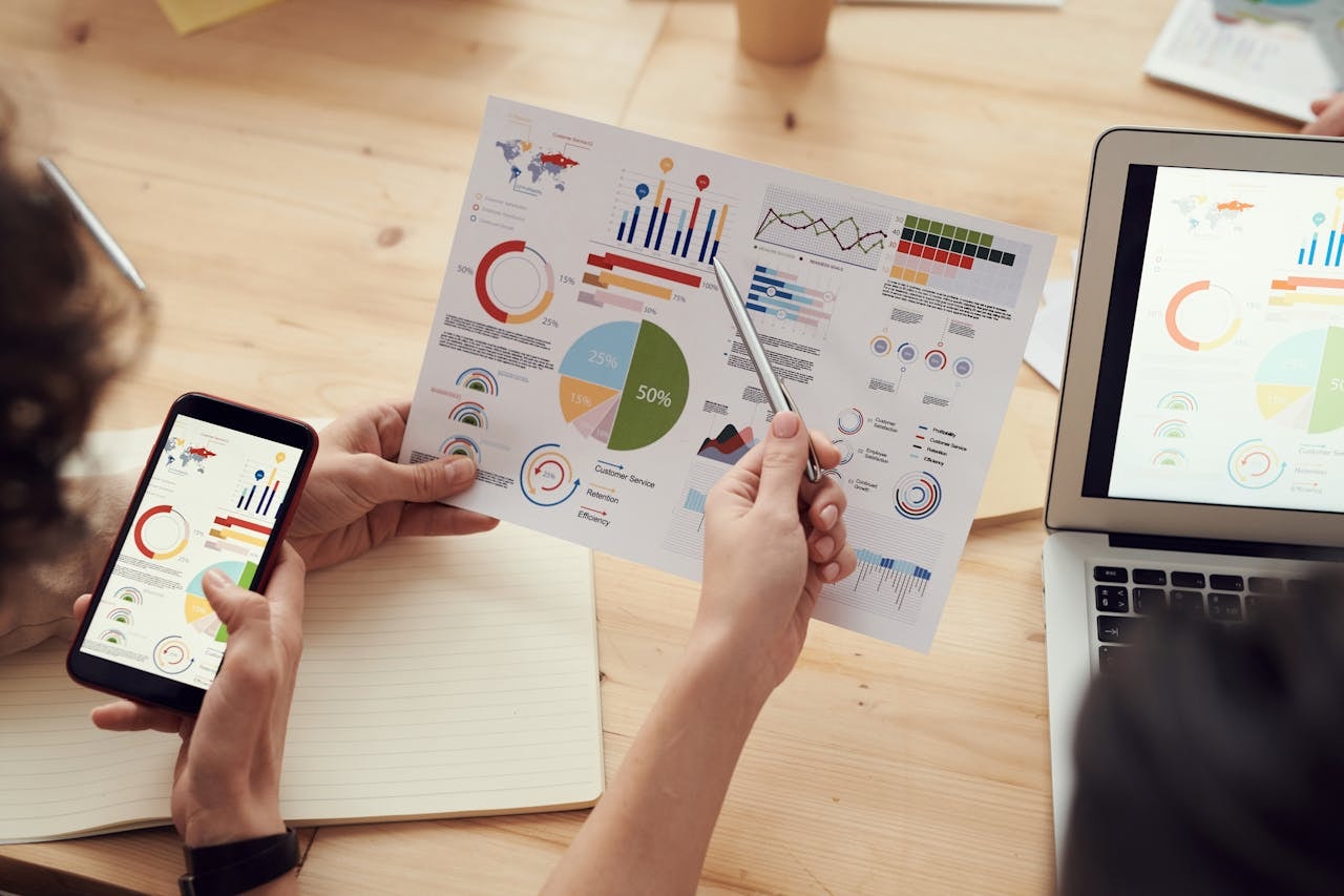 Two people looking at different types of charts