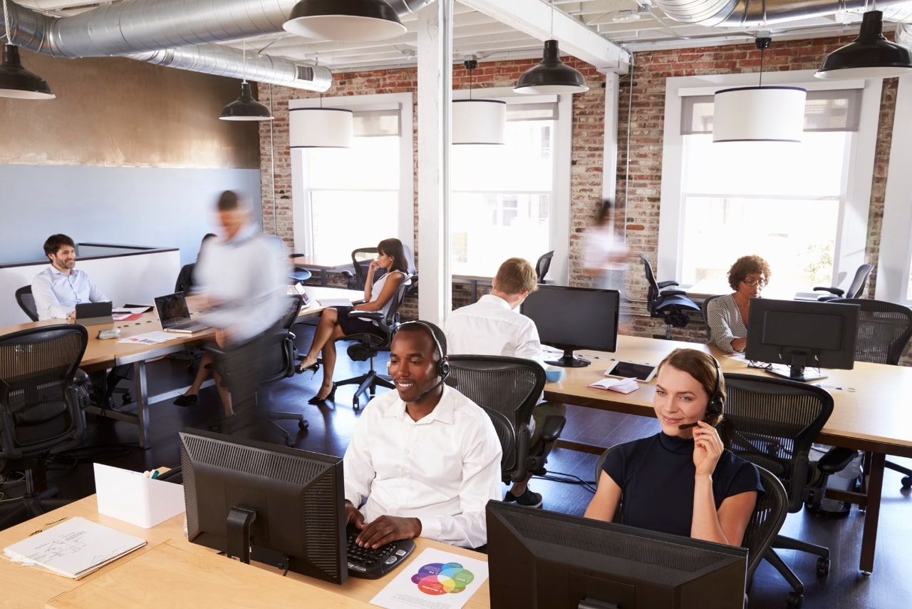View of call center representatives working in the office.