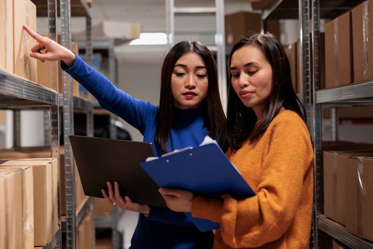 Warehouse worker and supply chain manager are tracking inventory