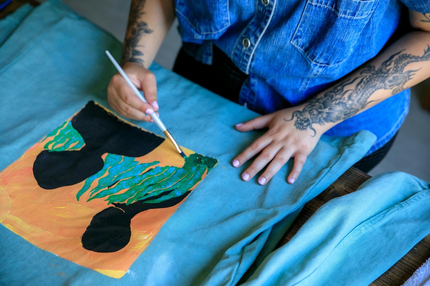 Woman is Painting on T-Shirt.