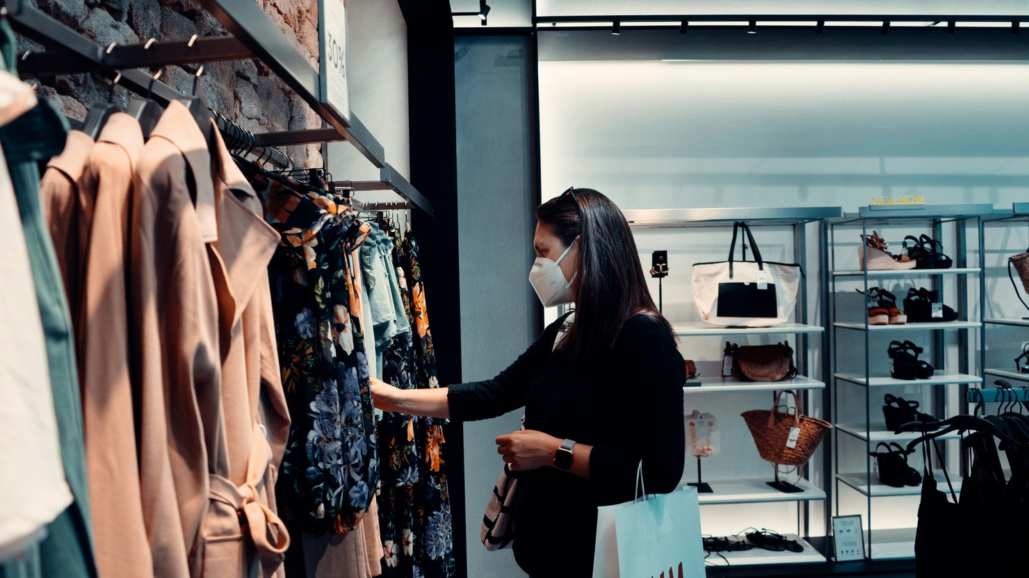 Woman sampling clothing products in a store.