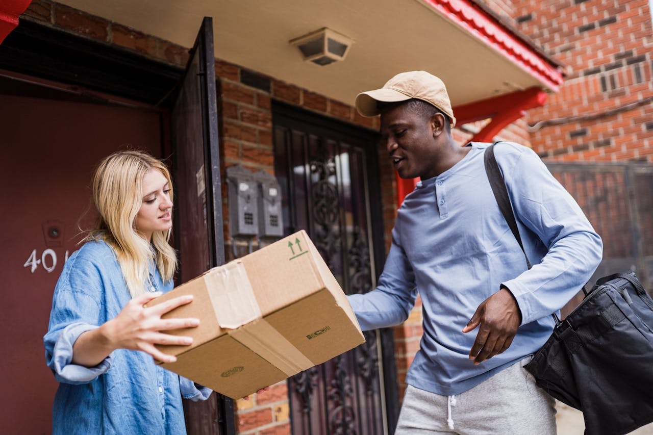 A customer receiving parcel from a delivery man
