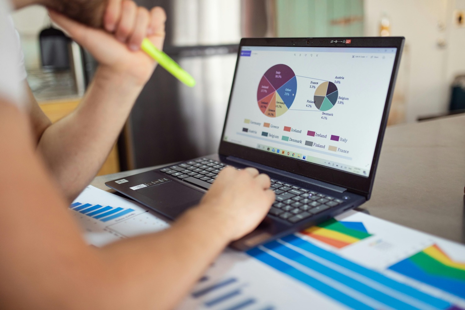 A laptop screen showing market trends, viewed by a person focused on the data.